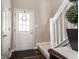 Inviting entryway with a white front door, hardwood floors, and a staircase with white railing at 9575 Thradd St, Fishers, IN 46038
