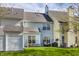 Back exterior view of townhome showing large backyard, patio area, and mature landscaping at 9575 Thradd St, Fishers, IN 46038