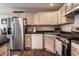 Bright kitchen features stainless steel appliances, wood cabinets and dark countertops and flooring at 9575 Thradd St, Fishers, IN 46038