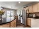 Bright kitchen features stainless steel appliances, wood cabinets, dark countertops and eat in breakfast nook at 9575 Thradd St, Fishers, IN 46038