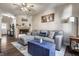 Spacious living room featuring a fireplace, gray sofa, and a rustic blue coffee table at 9575 Thradd St, Fishers, IN 46038