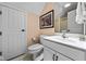 Bright bathroom with a framed picture, a white vanity, and a door to the toilet at 9626 Oakhaven Ct, Indianapolis, IN 46256