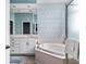 Bright bathroom features a soaking tub, white cabinets, and neutral tile flooring at 9626 Oakhaven Ct, Indianapolis, IN 46256