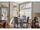 Charming breakfast nook with a round table, patterned chairs, and bright natural light from the windows at 9626 Oakhaven Ct, Indianapolis, IN 46256