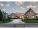 Charming brick home featuring a manicured lawn and a well-maintained landscape with a long driveway at 9626 Oakhaven Ct, Indianapolis, IN 46256