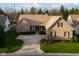 A beautiful brick house has green grass around the house and is surrounded by trees and plants at 9626 Oakhaven Ct, Indianapolis, IN 46256