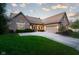 Beautiful brick home with well-manicured lawn and a spacious driveway leading to an attached garage at 9626 Oakhaven Ct, Indianapolis, IN 46256