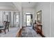 Elegant foyer with hardwood floors, a patterned rug, and a view to the large front windows at 9626 Oakhaven Ct, Indianapolis, IN 46256