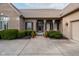 Inviting home entrance with decorative columns, manicured bushes, and charming chairs on the porch at 9626 Oakhaven Ct, Indianapolis, IN 46256