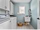Functional laundry room with washer, dryer, utility sink, and ample storage at 9626 Oakhaven Ct, Indianapolis, IN 46256