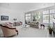 Bright living room with large windows, neutral colors, and comfortable seating, ideal for entertaining and relaxation at 9626 Oakhaven Ct, Indianapolis, IN 46256