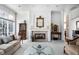 Beautiful living room featuring a fireplace, large windows, and elegant decor, flooded with natural light at 9626 Oakhaven Ct, Indianapolis, IN 46256