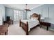 Serene bedroom with a wooden bed frame, neutral color scheme, large windows, and a ceiling fan for added comfort at 9626 Oakhaven Ct, Indianapolis, IN 46256