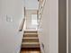 Carpeted stairway with wooden banister leading to the upper level at 9626 Oakhaven Ct, Indianapolis, IN 46256