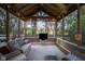 Relaxing sunroom with a vaulted ceiling, wicker furniture, and great backyard views at 9626 Oakhaven Ct, Indianapolis, IN 46256