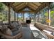 Relaxing sunroom with a vaulted ceiling, wicker furniture, and great backyard views at 9626 Oakhaven Ct, Indianapolis, IN 46256