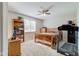 Bedroom showcasing a wooden bed frame, ceiling fan, and natural light at 990 Bull Run W Dr, Greenwood, IN 46143