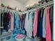 Walk-in closet well-organized with shelving, rods, and multiple storage options at 990 Bull Run W Dr, Greenwood, IN 46143