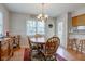 Bright dining area with wood table, chairs, and plenty of natural light at 990 Bull Run W Dr, Greenwood, IN 46143