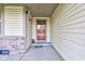Inviting covered porch with neutral siding and a decorative glass front door at 990 Bull Run W Dr, Greenwood, IN 46143