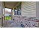 Charming covered front porch with brick accents, siding and plenty of natural light at 990 Bull Run W Dr, Greenwood, IN 46143