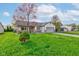 Charming single-story home with a lush green lawn and a cozy front porch at 990 Bull Run W Dr, Greenwood, IN 46143