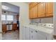 Laundry room features washer, dryer, and cabinetry adjacent to kitchen for easy access at 990 Bull Run W Dr, Greenwood, IN 46143