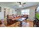 Inviting living room with leather furniture, ceiling fan, and wood flooring at 990 Bull Run W Dr, Greenwood, IN 46143