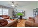 Bright living room with hardwood floors, neutral paint, and comfortable seating at 990 Bull Run W Dr, Greenwood, IN 46143