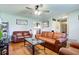 Cozy living room featuring leather furniture, wood floors, and bright natural light at 990 Bull Run W Dr, Greenwood, IN 46143