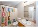Bathroom featuring a colorful shower curtain, a sink, and a mirror creating a vibrant and functional space at 10208 Clear Sky Dr, Avon, IN 46123