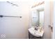 A half bath with a sink, vanity, and decorative mirror at 10208 Clear Sky Dr, Avon, IN 46123