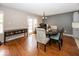 A dining room with hardwood floors, a table with chairs, and access to the backyard at 10208 Clear Sky Dr, Avon, IN 46123