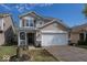 Charming two-story home with a two-car garage, landscaped yard, and inviting front porch with stone accents at 10208 Clear Sky Dr, Avon, IN 46123