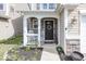Inviting front porch with stone accents, decorative wreath, and charming decor create a welcoming entrance at 10208 Clear Sky Dr, Avon, IN 46123
