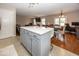 A spacious eat-in kitchen with white countertops, gray cabinets, and an adjacent living area at 10208 Clear Sky Dr, Avon, IN 46123