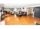 Open-concept living space with hardwood floors, seamlessly connecting the living room, dining area, and kitchen at 10208 Clear Sky Dr, Avon, IN 46123