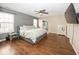 A bedroom with hardwood floors, a queen bed, and an accent wall at 10208 Clear Sky Dr, Avon, IN 46123