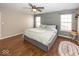 A bedroom with hardwood floors, a queen bed, and an accent wall at 10208 Clear Sky Dr, Avon, IN 46123