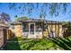 Charming brick home with screened-in porch and a lovely green lawn, perfect for outdoor relaxation and entertainment at 1031 N Lesley Ave, Indianapolis, IN 46219