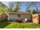 Backyard with chairs and a brick building with an open fire pit at 1031 N Lesley Ave, Indianapolis, IN 46219