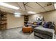 Finished basement with a carpeted floor, gray sectional, and wood accents at 1031 N Lesley Ave, Indianapolis, IN 46219