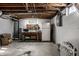 Unfinished basement featuring workbench, tool storage, and concrete floors at 1031 N Lesley Ave, Indianapolis, IN 46219