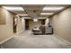 Large finished basement with a gray sectional, wood accents, and carpeted floor at 1031 N Lesley Ave, Indianapolis, IN 46219