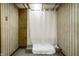 Cozy bathroom featuring a walk-in shower with a decorative shower curtain and storage at 1031 N Lesley Ave, Indianapolis, IN 46219