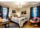 Bedroom with a fun bedspread, desk, hardwood flooring, and natural light at 1031 N Lesley Ave, Indianapolis, IN 46219