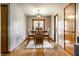 Charming dining area with modern light fixture and wooden table set for four, with hardwood floors and patterned accent wall at 1031 N Lesley Ave, Indianapolis, IN 46219