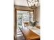 Bright dining room with table and flowers, and door leading to screened in porch and backyard at 1031 N Lesley Ave, Indianapolis, IN 46219