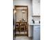 Open kitchen view to dining area with chandelier and wood table, white subway tile backsplash and stainless steel refrigerator at 1031 N Lesley Ave, Indianapolis, IN 46219