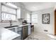 Bright kitchen featuring stainless steel appliances, subway tile backsplash and light blue cabinets, with a window over the sink at 1031 N Lesley Ave, Indianapolis, IN 46219